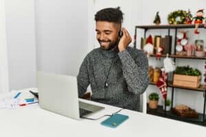 Call center agent at a desk with holiday decoration behind