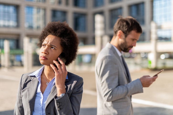 woman on phone possibly hearing hold music or messages on hold