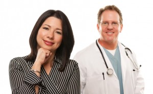 Attractive Hispanic Woman with Male Doctor or Nurse Isolated on a White Background.