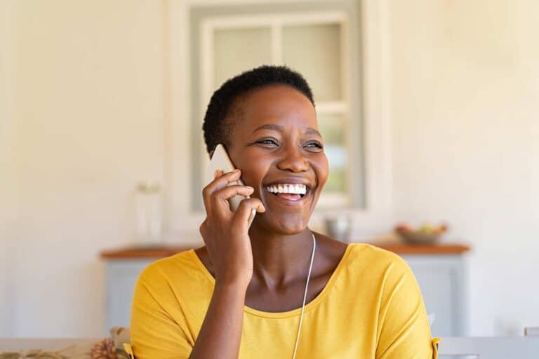 Easy On Hold | Blog - smiling woman on phone call